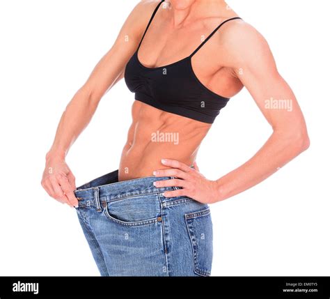 Woman Shows Her Weight Loss By Wearing An Old Jeans Stock Photo Alamy