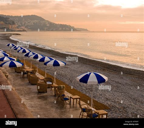 Distinctive Blue And White Beach Umbrellas Line The Pebble Beach At