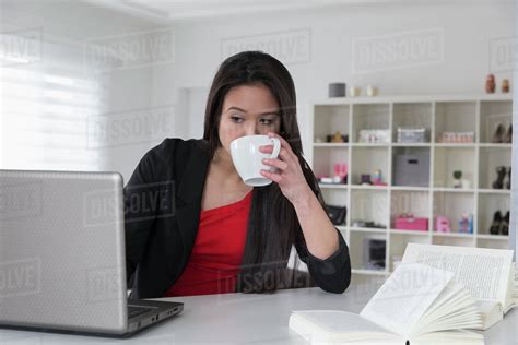 Mixed Race Businesswoman Using Laptop Stock Photo Dissolve