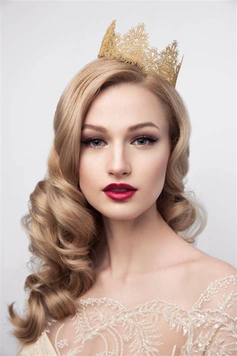 A Woman Wearing A Tiara With Long Hair And Red Lipstick On Her Lips Is Looking At The Camera