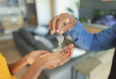Close Up Man Giving House Keys To Woman Stock Photo