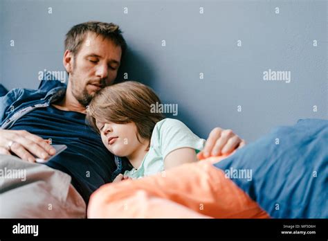 Father And Son Sleeping At Home Stock Photo Alamy