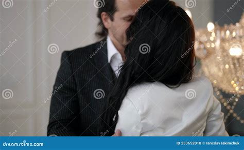 Groom Is Hugging And Kissing His Slender Young Bride In Wedding Day