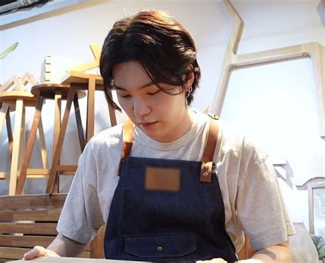 A Woman In An Apron Is Working On Something