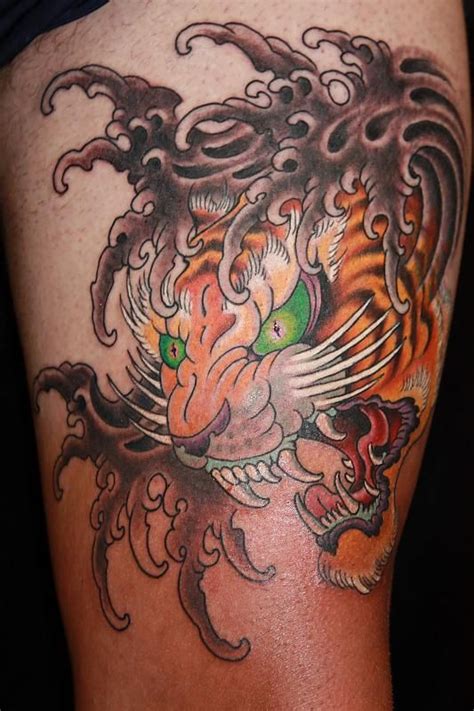 This powerful combo of the tiger and dragon tattoo says more than just strength and dominance as it is the one of the most power demonstrating designs that can be inked out of the various designs of the tiger tattoo gallery. Awesome Tiger Head Tattoo On Sleeve - Tiger Tattoo Designs ...