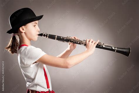 Little Girl Playing Clarinet On A Gray Background Stock Photo Adobe Stock