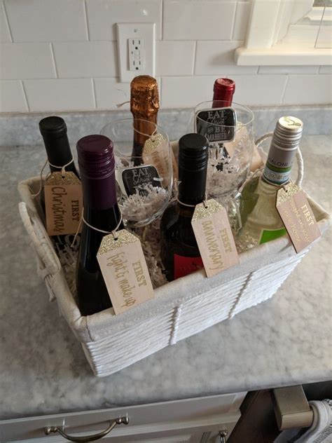 Wine Bottles In A Basket With Tags On Them Sitting On A Kitchen Counter