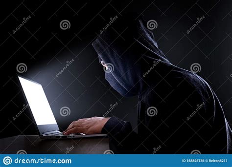 Cybercrime Hacking And Technology Concept Male Hacker In Dark Room Writing Code Or Using