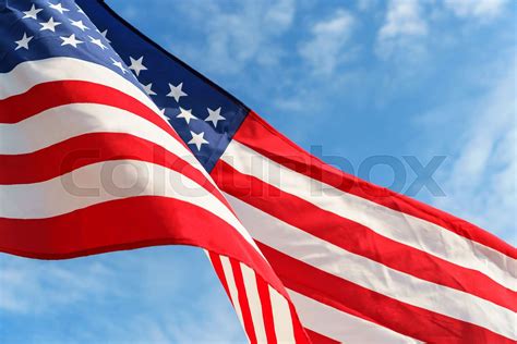 Waving Star And Stripes American Flag On The Blue Sky Stock Image