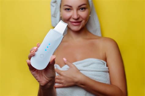 premium photo ultrasonic scrubber for facial skin cleansing girl in the bathroom takes care