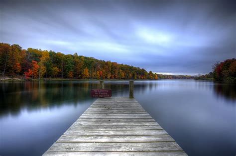 Gray Wooden Dock Autumn The Sky Water Trees Clouds Surface