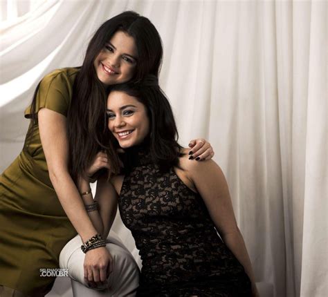 Two Women Posing For A Photo In Front Of A White Curtain With Their Arms Around Each Other