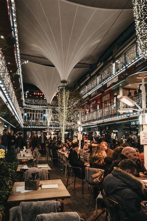 People Sitting At The Tables Inside Kingly Court Decorated With