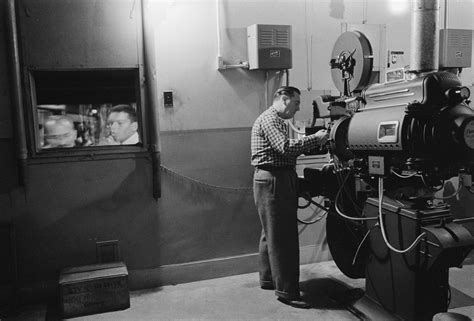 Fileman Working With A Projector In A Movie Theater 1958