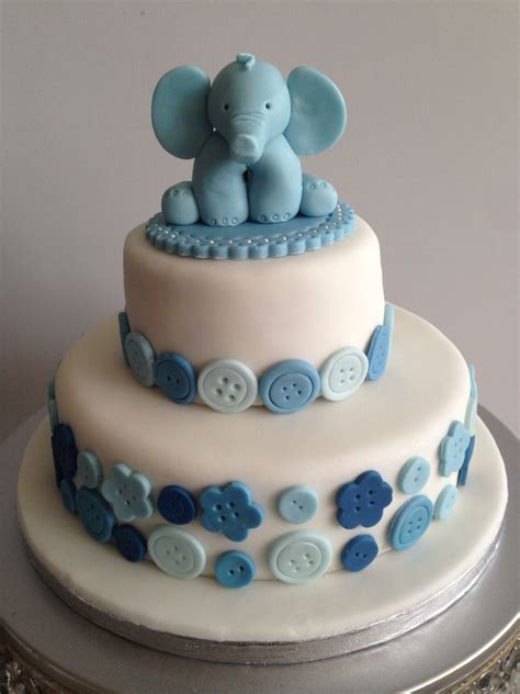 Boy blowing out candles on a birthday cake against blue background. Blue elephant, Boys baby shower/first birthday cake | Smash cake boy, First birthday cakes ...