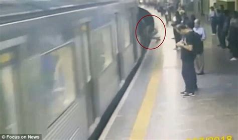 The Moment Woman Is Pushed Under Train But Survives Daily Mail Online