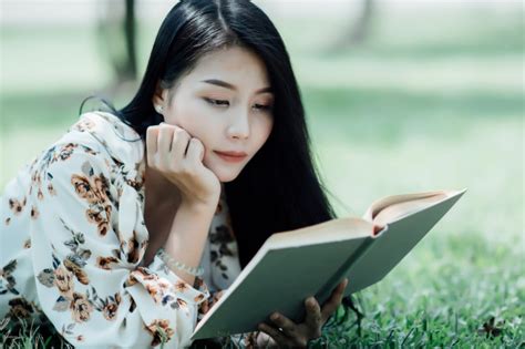 Los personajes no son mios. Hermosa chica leyendo un libro en el parque en la luz del sol de verano | Foto Gratis
