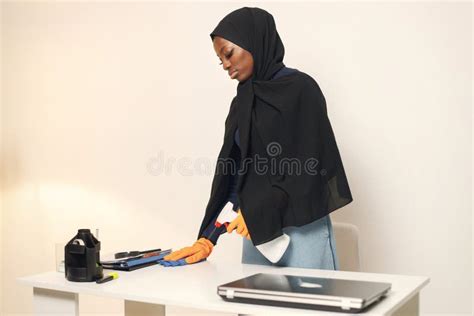 arabic female maid in cleaning gloves cleaning a workspace stock image image of household