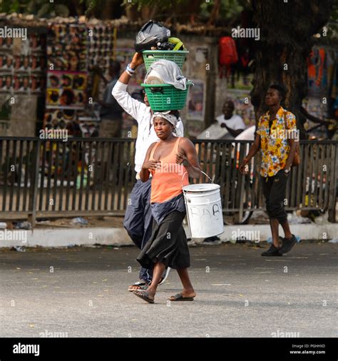 accra ghana jan 8 2017 unidentified ghanaian woman carries a basket on her head people of