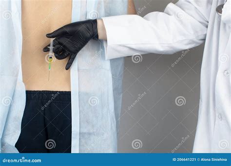 An Orthopedic Surgeon Gives An Injection In The Sacrum Treatment Of