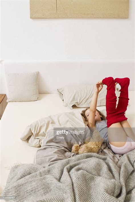 Girl Getting Dressed On Bed Bildbanksbilder Getty Images