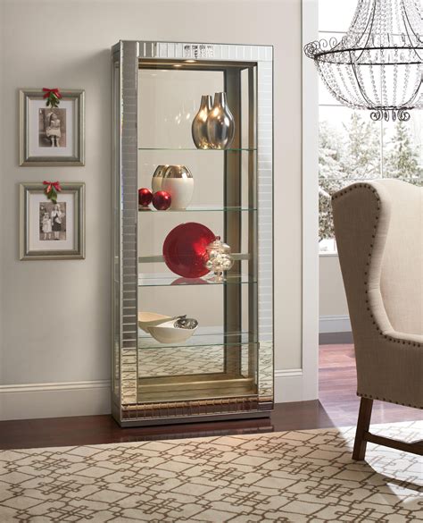 Display your favorite memorabilia or your favorite family photos in a curio cabinet. Argus Mirrored Curio | Glass curio cabinets, Mirror, Home deco