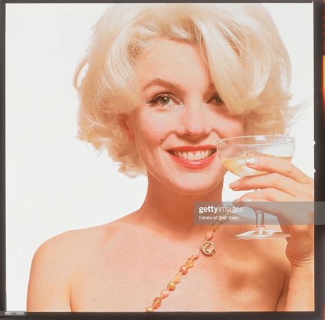 American Actress Marilyn Monroe Holding A Glass Of Champagne Beverly