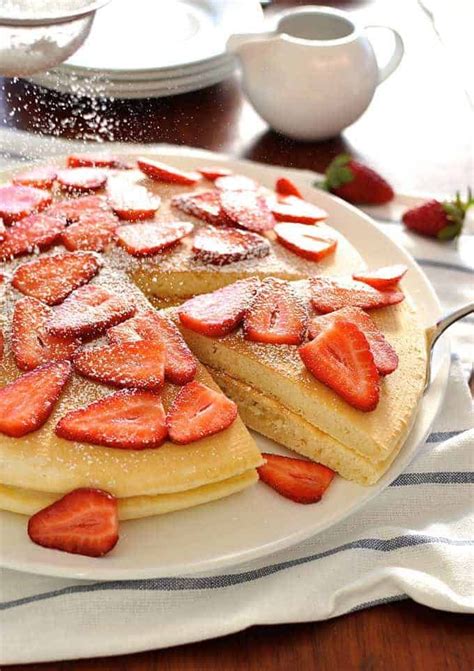 Giant Pancake Topped With Strawberries Sprinkled With Icing Sugar Fast