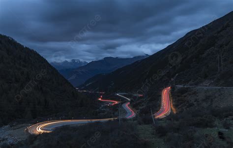 Long Exposure Photography Of Night Car Track Road On Snowy Mountain