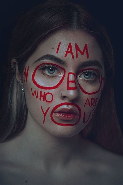 A Woman With Painted Face And Words On Her Face In The Shape Of An I Am