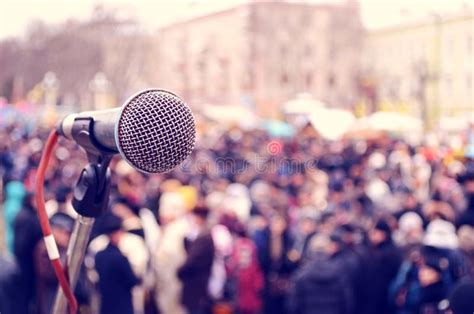 Abstract Image With A Microphone On The Background Of A Crowd At A