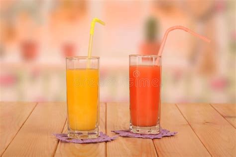 Two Glasses Of Fresh Orange And Grapefruit Juices Straws On Kit Stock