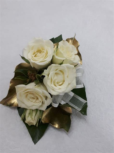 White Mini Spray Roses With Gold Sprayed Leaves And A Touch Of Ribbon