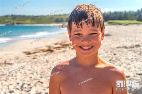 A Happy Smiling Young Boy At The Beach In The Summer Stock Photo