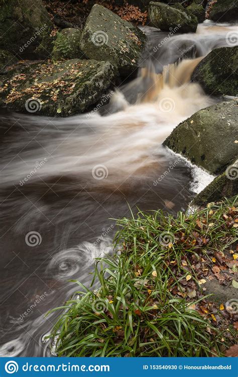 Close Up Of Stream Flowing Over Rocks In Autumn Fall Forest Landscape