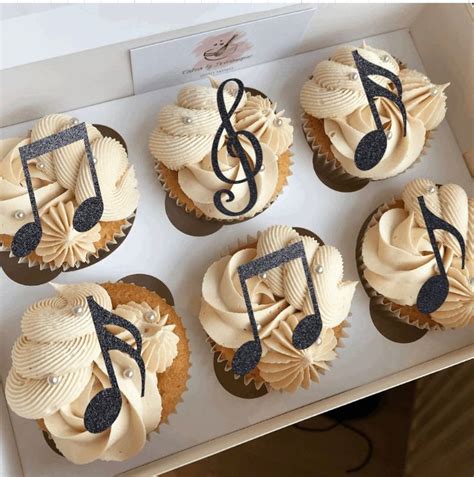 Cupcakes Decorated With Music Notes And Musical Symbols Are Displayed
