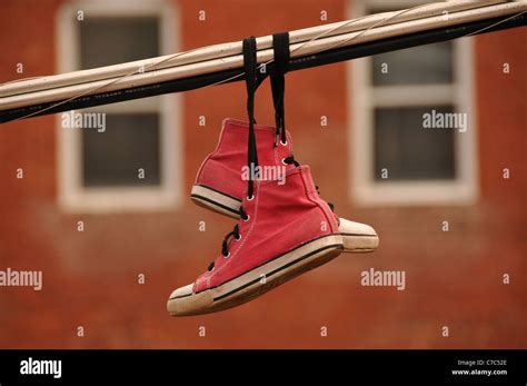 Pink High Top Canvas Shoes Hang From Utility Wires In Bisbee Arizona