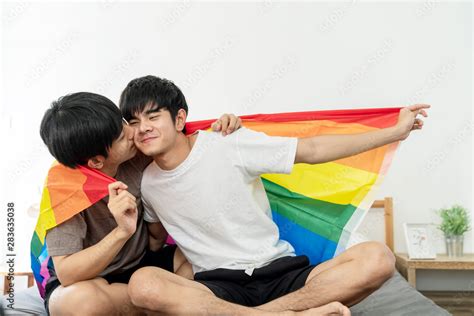 Portrait Of Happy Asian Gay Couple Smiling On Face Kissing Together