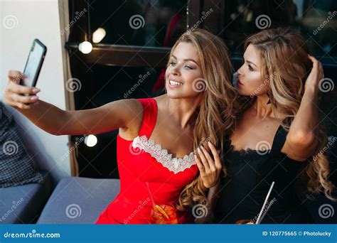 two attractive girls taking selfie together stock image image of blonde cafe 120775665