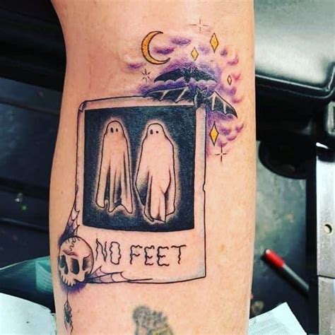 There Is A Tattoo On The Leg Of A Person With Two Ghostes In It