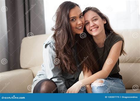 happy smiling sisters on the couch stock image image of couch inside 120307775