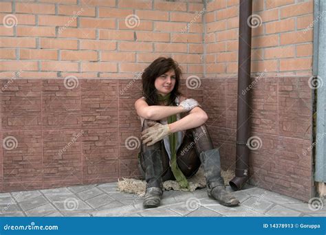 A Homeless Girl Is Standing On A Garbage Dump With A Houseplant In A Pot Royalty Free Stock