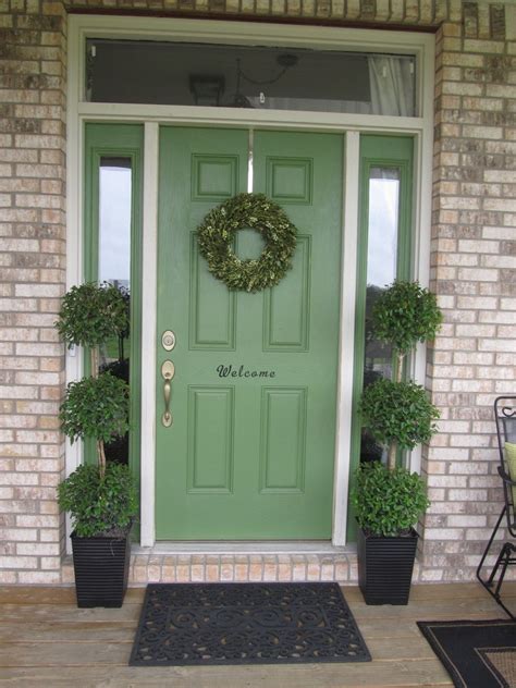 Olive Door Color And Glasses Flanked By The Stack Of Brick Walls With