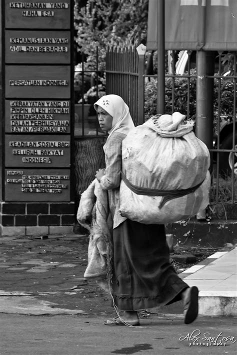 The Burden Of Poverty Woman With Burden On Her Back Walks Flickr