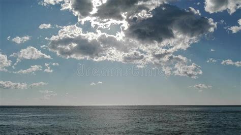 Mesmerizing Cloudscape Over The Calm Sea With A Clear Skyline Stock