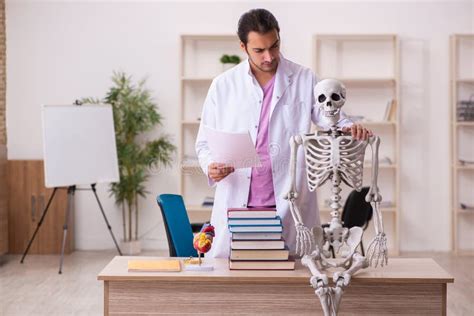 Young Male Doctor Student Studying Human Skeleton In The Classroom