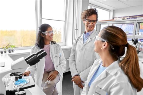 Scientists With Microscopes Working In Laboratory Stock Image Image