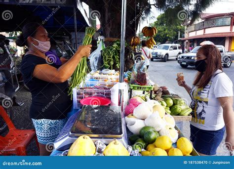 Customer Buy Fresh Fruit And Vegetable From A Vendor At Her Makeshift Stall Along A Sidewalk