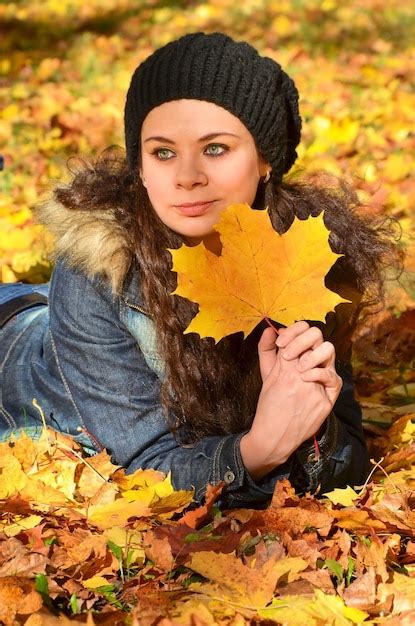 Premium Photo Young Woman Relaxing In Bright Autumn Leaves