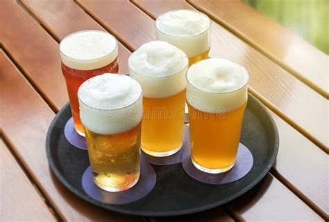Five Cold Beers With Frothy Heads In Glasses On A Tray Stock Photo